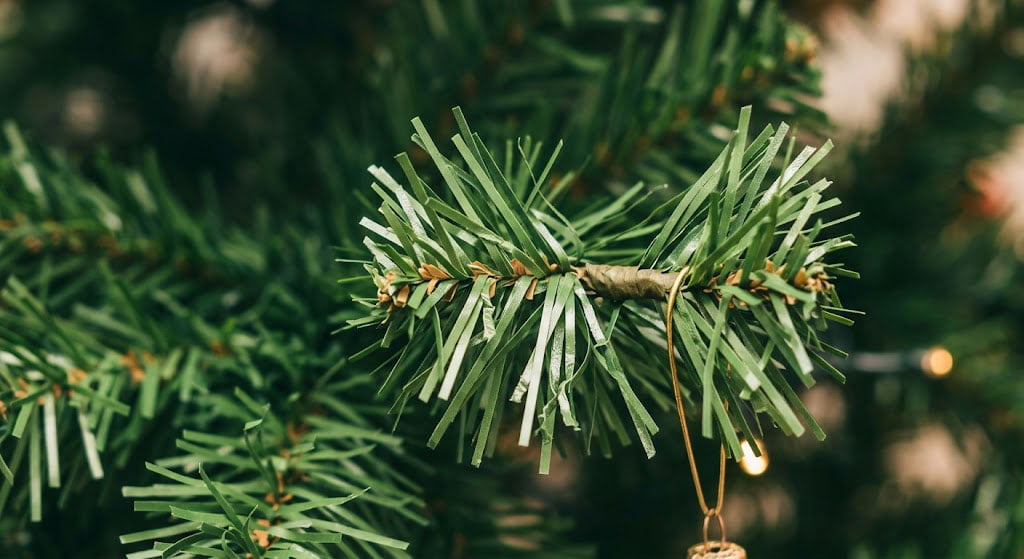 Close-up of traditional pvc artificial christmas trees showing flat needle design